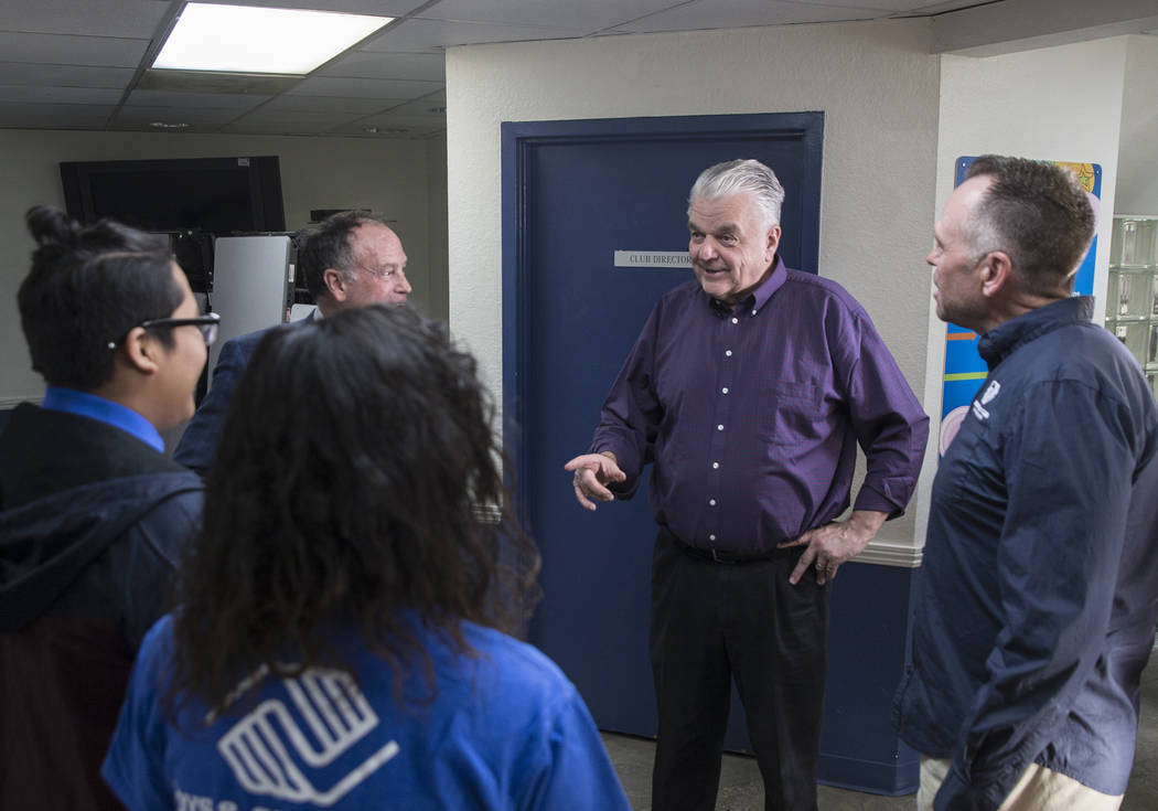 Governor-elect Steve Sisolak, middle, talks with Boys & Girls Clubs CEO Andy Bischel, right, and team ambassadors during a visit to the Boys & Girls Clubs of Southern Nevada on Thursday, J ...
