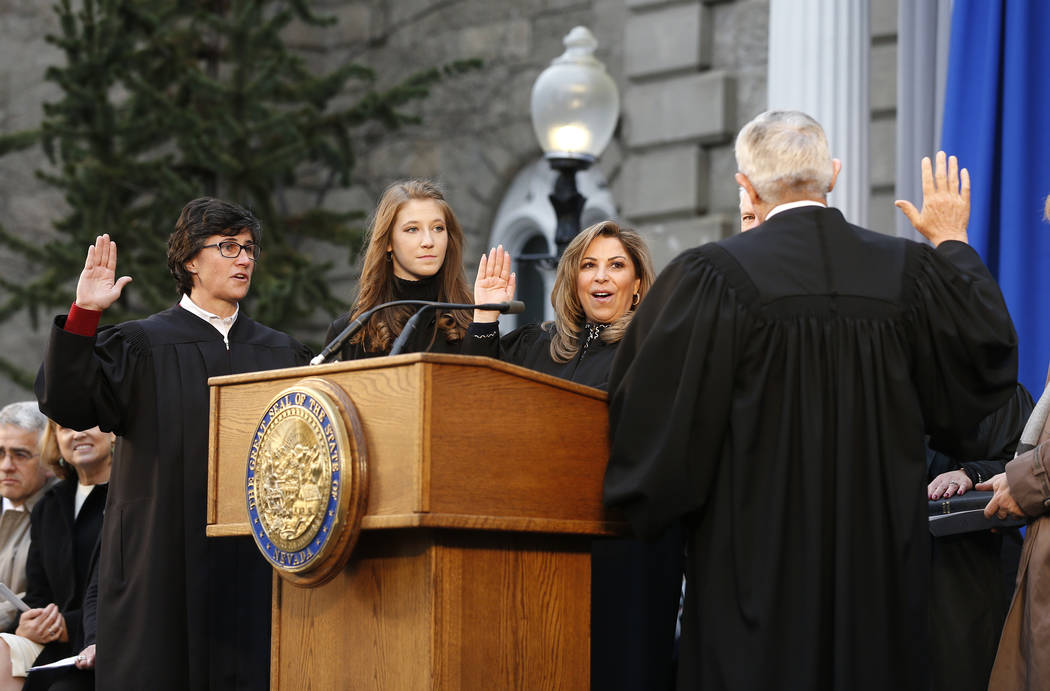 Nevada Supreme Court Justices, Lidia Siglich, left, Abbi Silver, center, and Elissa Cadish, not seen, take the oath of office with Supreme Court Chief Justice James Hardesty during the inaugurati ...