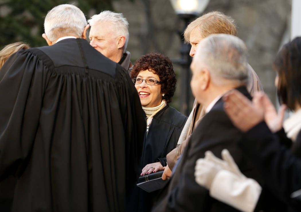 Nevada Supreme Court Chief Justice James Hardesty congratulates Justice Elissa Cadish, center, after she is sworn in during the inauguration at the Capitol, in Carson City, Nev., on Monday, Jan. 7 ...