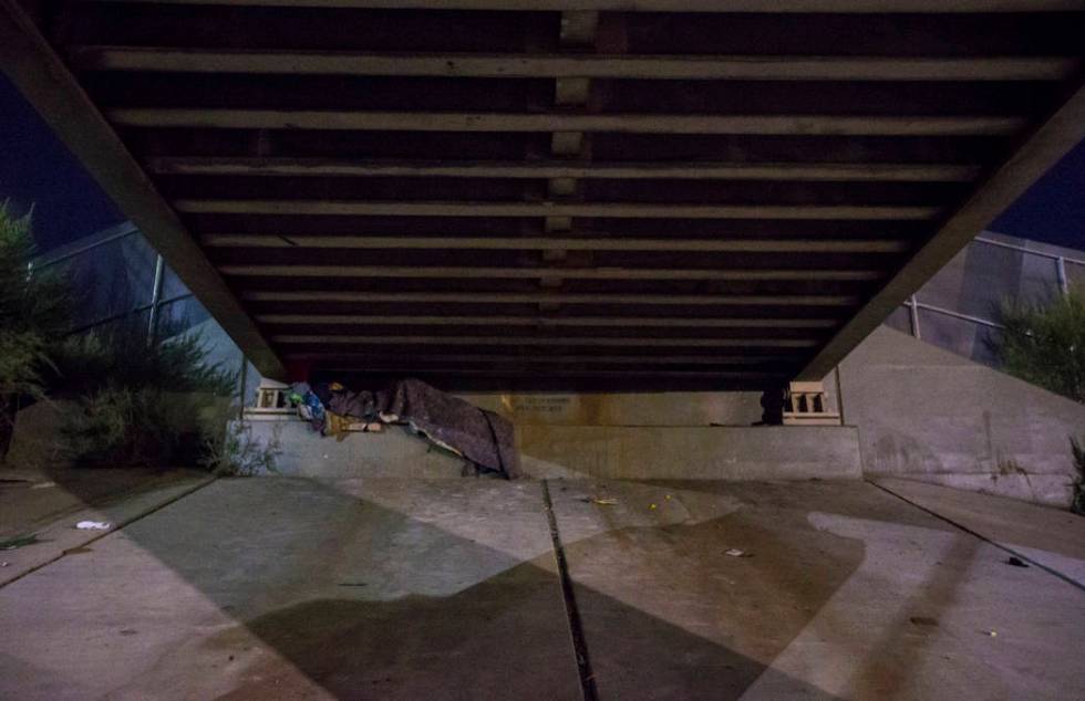 A homeless individual sleeps beneath an underpass along Owens Avenue as the annual Southern Nev ...