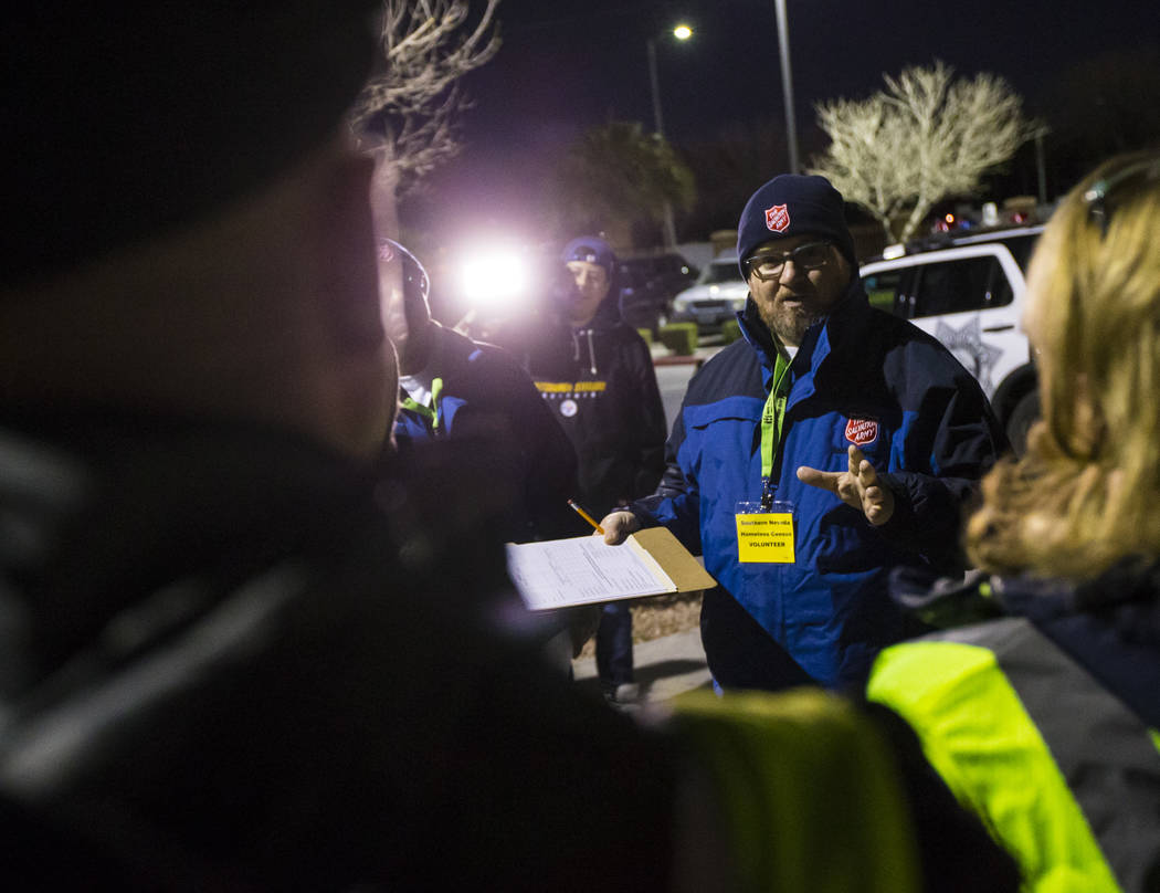 Ryan McDonald, homeless service coordinator at Salvation Army, talks with volunteers and partic ...