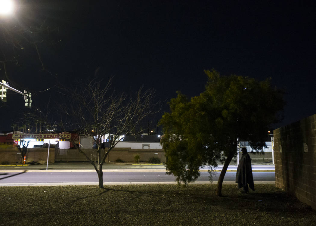 A homeless man is silhouetted along Main Street near Owens Avenue as the annual Southern Nevada ...