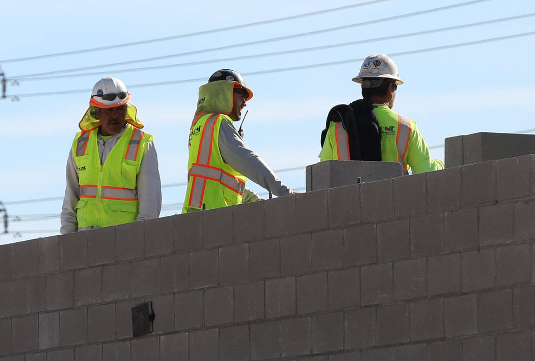 Workers lay concrete block at the construction site at the northeast corner of Fort Apache and Russell roads on Wednesday, Jan, 30, 2019, in Las Vegas. (Bizuayehu Tesfaye/Las Vegas Review-Journal) ...