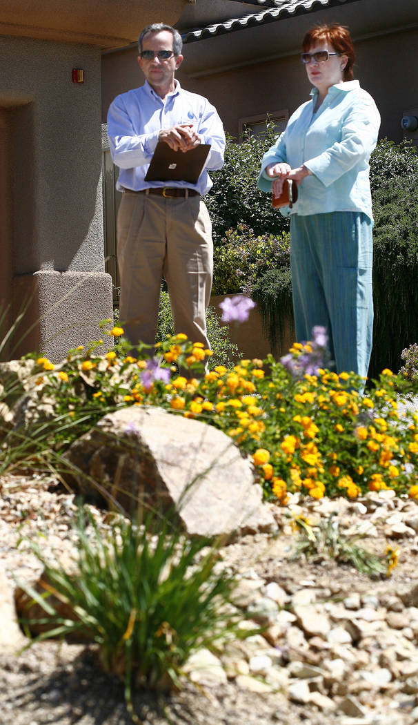 Southern Nevada Water Authority Conservation Manager Doug Bennett (left) looks over the front yard landscaping of homeowner Kathy Gillespie in May 2008. (Review-Journal file)