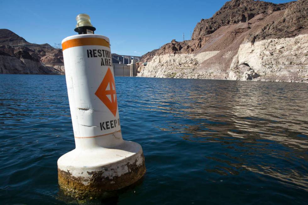 A buoy marks the restricted area to the Hoover Dam intake towers along the Colorado River's Black Canyon at Lake Mead National Recreation Area outside of Las Vegas, Nev., on Wednesday, Oct. 17, 20 ...