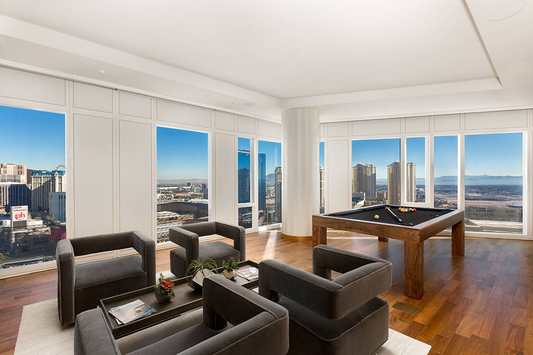 The living room in Waldorf Astoria unit No. 2403 has lots of windows for Strip views. (Luxury Estates International)