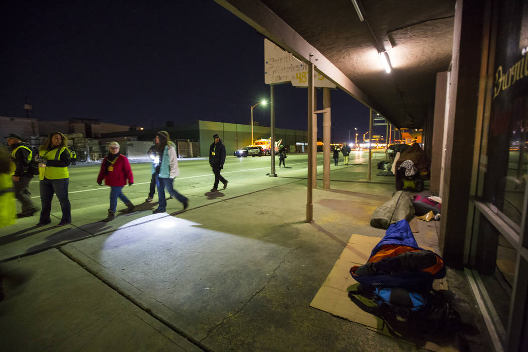 Homeless people sleep outside of businesses along Main Street as volunteers walk the area for the annual Southern Nevada Homeless Census goes on in Las Vegas on Tuesday, Jan. 22, 2019. (Chase Stev ...
