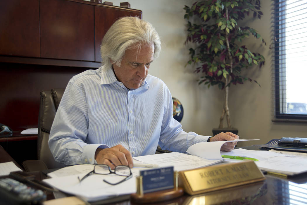 Robert A. Massi reviews paperwork inside his Henderson law offices on Monday, Aug. 15, 2016. His son Robert currently works with the law firm, and son Dominic operates his own insurance business. ...