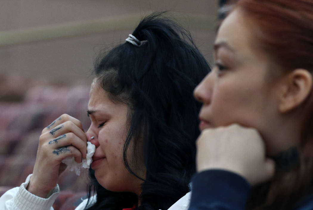 Amber Bustillos, left, a fiance of Junior Lopez, a man fatally shot by Las Vegas police in April, weeps as her friend Carla Varela looks on during a public review of Lopez death on Thursday, Feb. ...