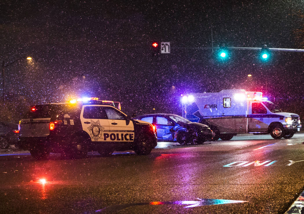 Las Vegas Metro works to secure the scene of an accident at North Durango Drive and West Centennial Parkway in heavy snow on Wednesday, Feb. 20, 2019, in Las Vegas. (Benjamin Hager Review-Journal) ...