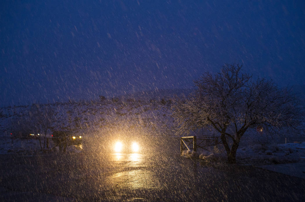 Vehicles pull into the overlook at the Red Rock Canyon National Conservation Area as snow falls outside of Las Vegas on Wednesday, Feb. 20, 2019. (Chase Stevens/Las Vegas Review-Journal) @cssteven ...