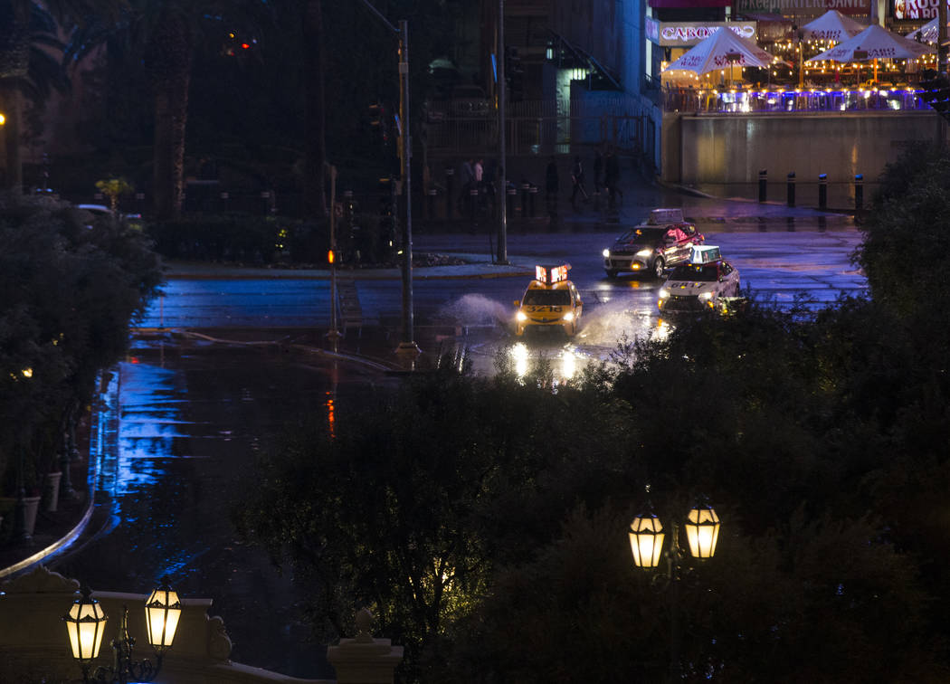 Taxis pull into the Bellagio as snow falls in Las Vegas on Wednesday, Feb. 20, 2019. (Chase Stevens/Las Vegas Review-Journal) @csstevensphoto