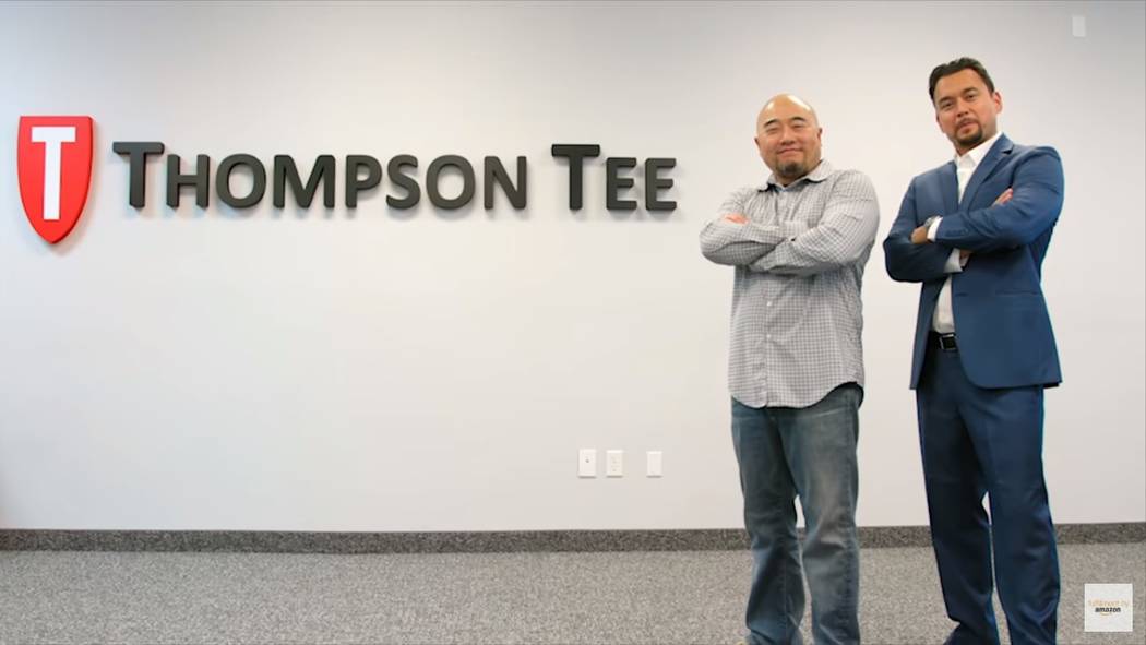 Co-founders Randy Choi, left, and Billy Thompson, right, pose in front of the Thompson Tee logo. (Courtesy)