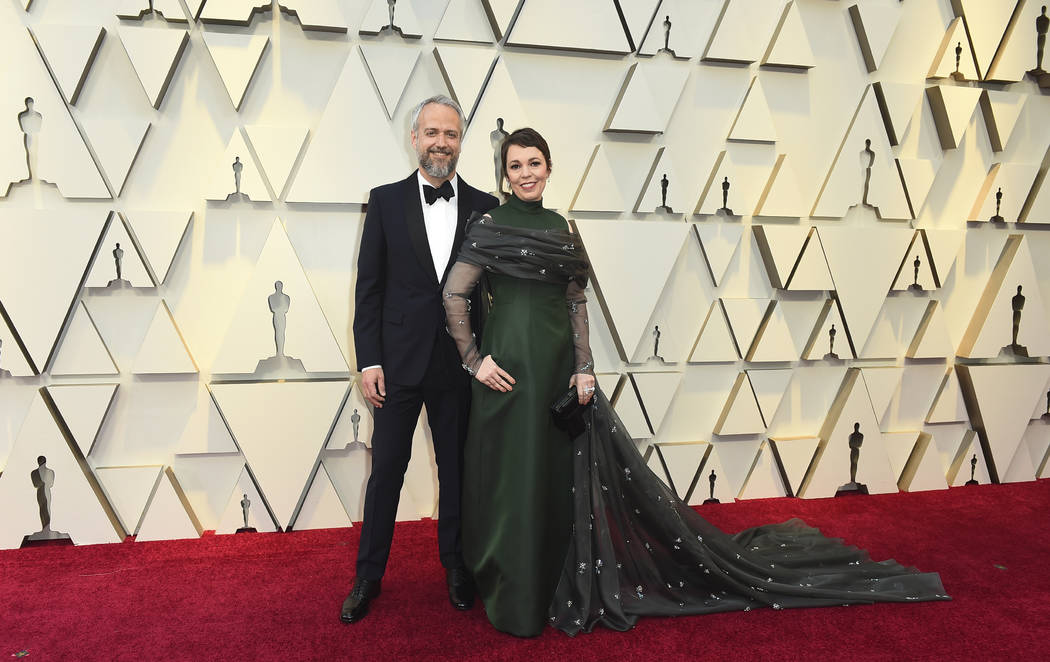 Ed Sinclair, left, and Olivia Colman arrive at the Oscars on Sunday, Feb. 24, 2019, at the Dolby Theatre in Los Angeles. (Photo by Jordan Strauss/Invision/AP)