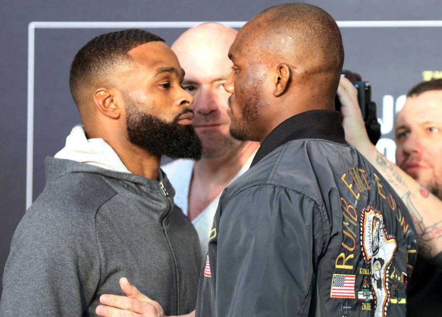 UFC welterweight champion Tyron Woodley, left, faces off with Kamaru Usman, right, as UFC president Dana White watches at UFC 235 media day at the T-Mobile Arena in Las Vegas, Wednesday, Feb. 27, ...