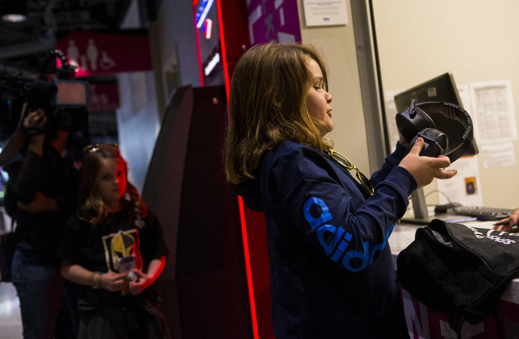 Christian Mouer, 11, holds up noise-cancelling headphones after picking up a sensory bag at before a Golden Knights game at T-Mobile Arena in Las Vegas on Tuesday, Feb. 26, 2019. The sensory bag f ...