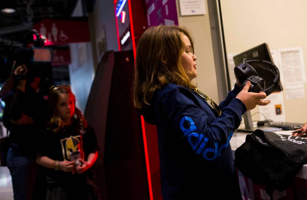 Christian Mouer, 11, holds up noise-cancelling headphones after picking up a sensory bag at before a Golden Knights game at T-Mobile Arena in Las Vegas on Tuesday, Feb. 26, 2019. The sensory bag f ...