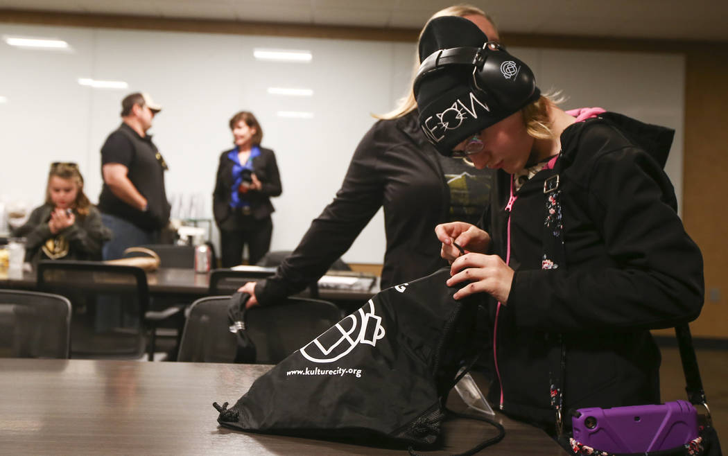 Kristlynn Allison, 11, looks through her sensory bag before a Golden Knights game at T-Mobile Arena in Las Vegas on Tuesday, Feb. 26, 2019. The sensory bag features noise-cancelling headphones, fi ...