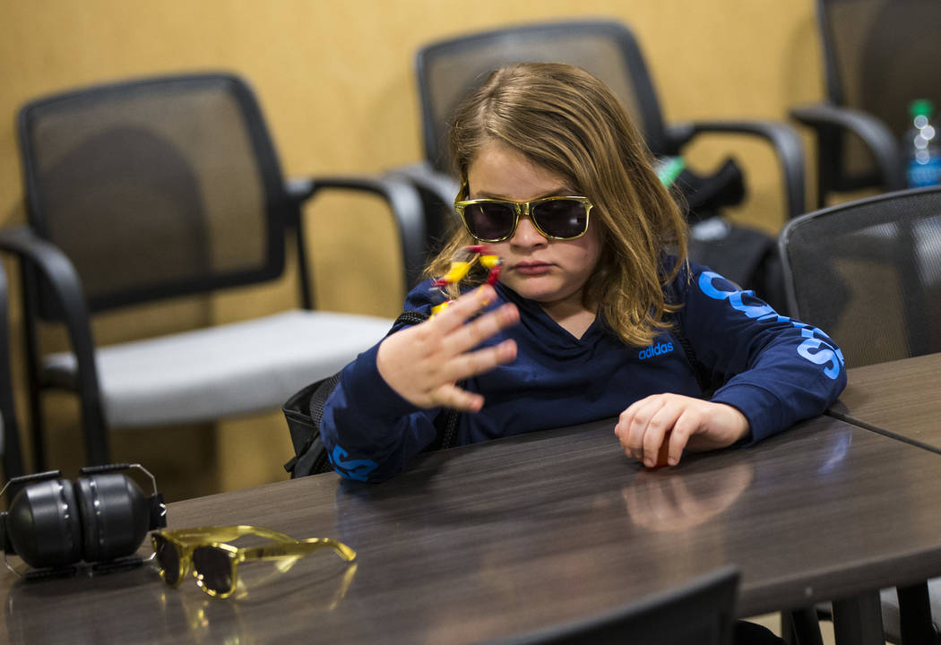 Christian Mouer, 11, plays with a fidget toy from a sensory bag before a Golden Knights game at T-Mobile Arena in Las Vegas on Tuesday, Feb. 26, 2019. The sensory bag features noise-cancelling hea ...