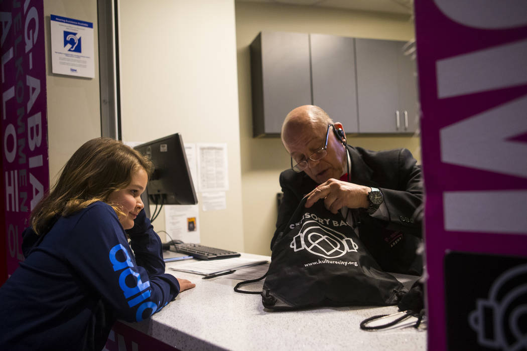 Christian Mouer, 11, is assisted by Bob T. of guest services with an a sensory bag before a Golden Knights game at T-Mobile Arena in Las Vegas on Tuesday, Feb. 26, 2019. The sensory bag features n ...