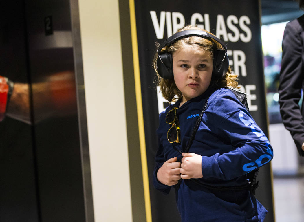 Christian Mouer, 11, walks around the arena with noise-cancelling headphones that he picked up with a sensory bag before a Golden Knights game at T-Mobile Arena in Las Vegas on Tuesday, Feb. 26, 2 ...
