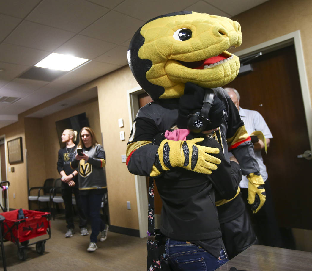 Kristlynn Allison, 11, gets a hug from Golden Knights mascot Chance before a hockey game at T-Mobile Arena in Las Vegas on Tuesday, Feb. 26, 2019. (Chase Stevens/Las Vegas Review-Journal) @cssteve ...