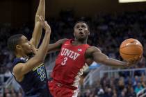 UNLV's Amauri Hardy shoots around UNR's Josh Hall during the second half of an NCAA college basketball game in Reno, Nev., Wednesday, Feb. 7, 2018. (AP Photo/Tom R. Smedes)
