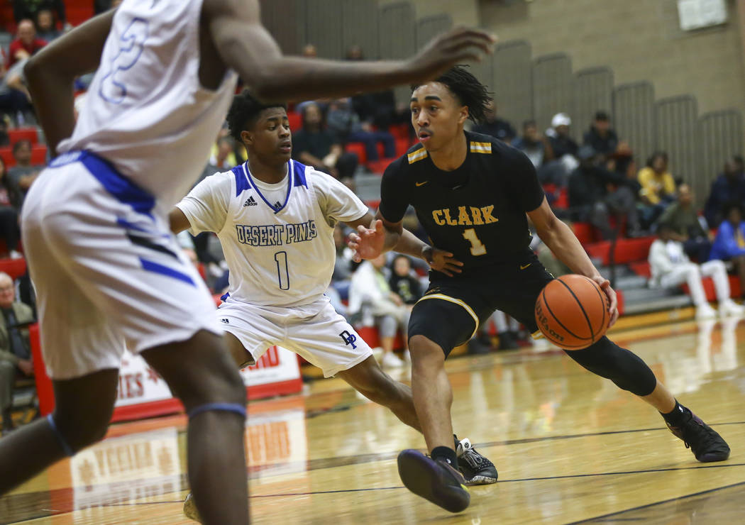 Clark's Frankie Collins (1) drives against Desert Pines' Semaj Threats (1) during the second half of a Class 4A state boys basketball quarterfinal game at Arbor View High School in Las Vegas on We ...