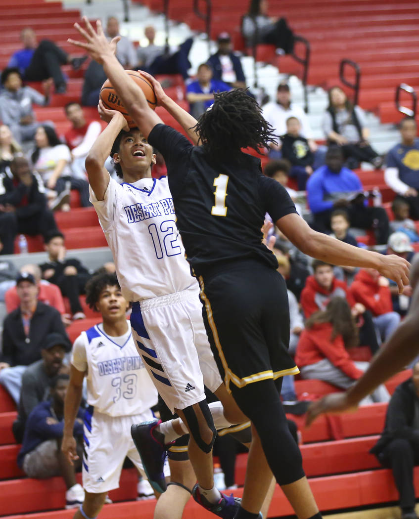 Desert Pines' Milos Uzan (12) shoots against Clark's Frankie Collins (1) during the first half of a Class 4A state boys basketball quarterfinal game at Arbor View High School in Las Vegas on Wedne ...