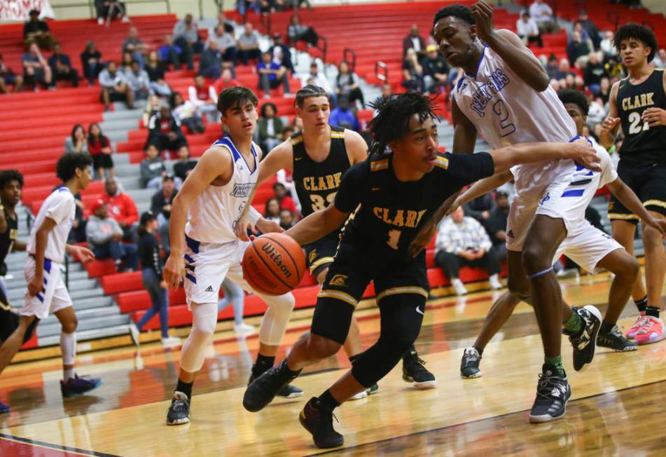 Clark's Frankie Collins (1) moves the ball around Desert Pines' Dayshawn Wiley (2) during the first half of a Class 4A state boys basketball quarterfinal game at Arbor View High School in Las Vega ...