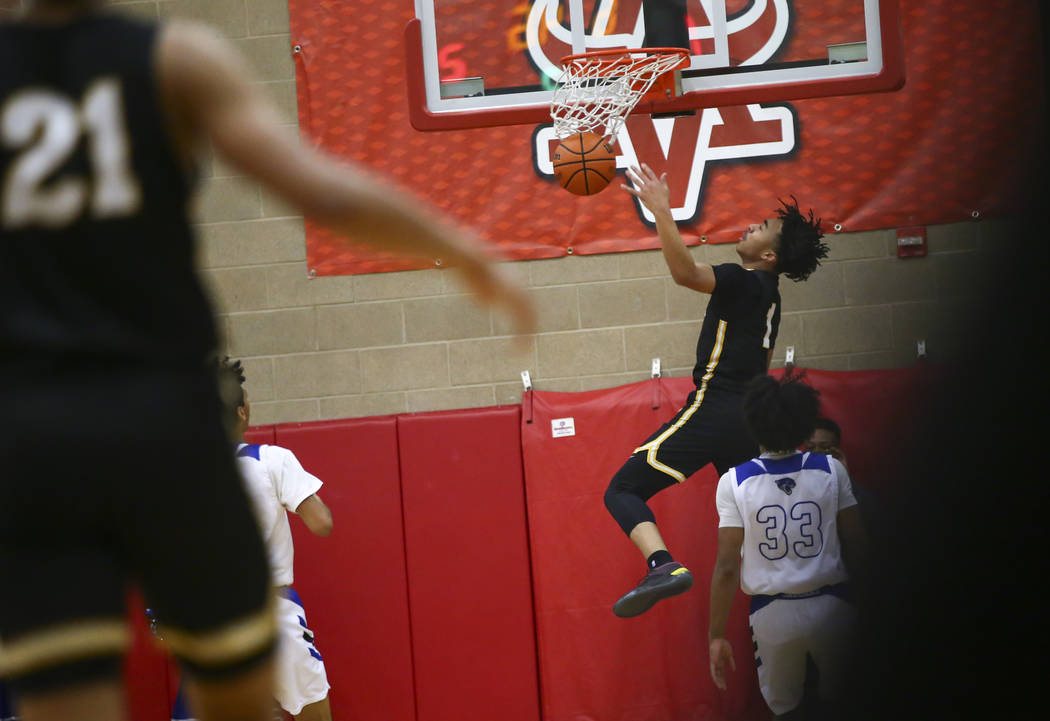 Clark's Frankie Collins (1) dunks against Desert Pines during the first half of a Class 4A state boys basketball quarterfinal game at Arbor View High School in Las Vegas on Wednesday, Feb. 27, 201 ...