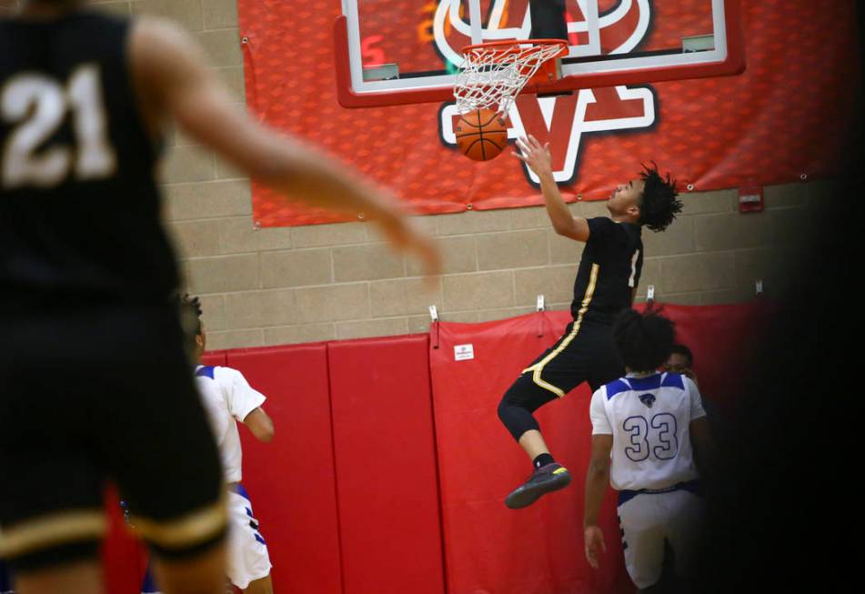 Clark's Frankie Collins (1) dunks against Desert Pines during the first half of a Class 4A state boys basketball quarterfinal game at Arbor View High School in Las Vegas on Wednesday, Feb. 27, 201 ...