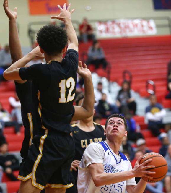 Desert Pines' Roland Gates (35) looks to shoot past Clark's Cameron Kimble (12) during the first half of a Class 4A state boys basketball quarterfinal game at Arbor View High School in Las Vegas o ...