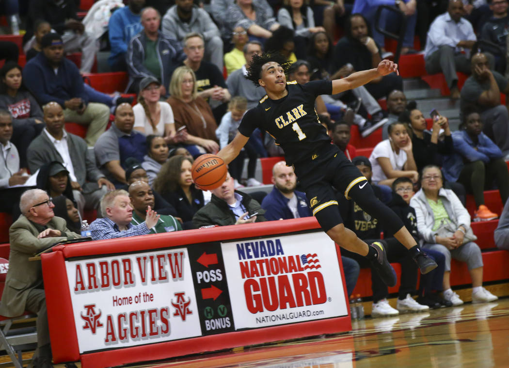 Clark's Frankie Collins (1) tries to keep the ball in during the first half of a Class 4A state boys basketball quarterfinal game against Desert Pines at Arbor View High School in Las Vegas on Wed ...