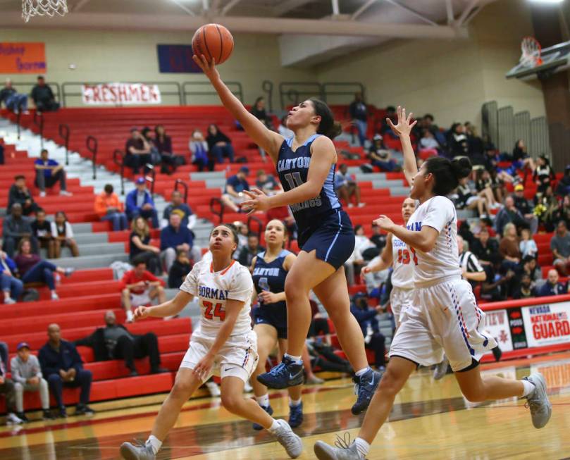Canyon Springs' Jeanette Fine (11) goes to the basket over Bishop Gorman's Bentleigh Hoskins (24) during the second half of a Class 4A state girls basketball quarterfinal game at Arbor View High S ...