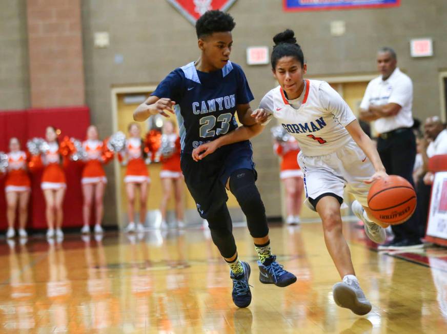 Bishop Gorman's Caira Young (1) drives the ball against Canyon Springs' Kayla Johnson (23) during the first half of a Class 4A state girls basketball quarterfinal game at Arbor View High School in ...
