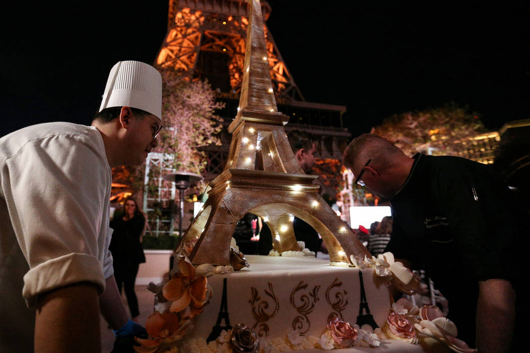 Servers bring out an Eiffel Tower shaped cake as the Paris Las Vegas debuts a new $1.7 million Eiffel Tower light show on the Strip in Las Vegas, Wednesday, Feb. 27, 2019. (Caroline Brehman/Las Ve ...