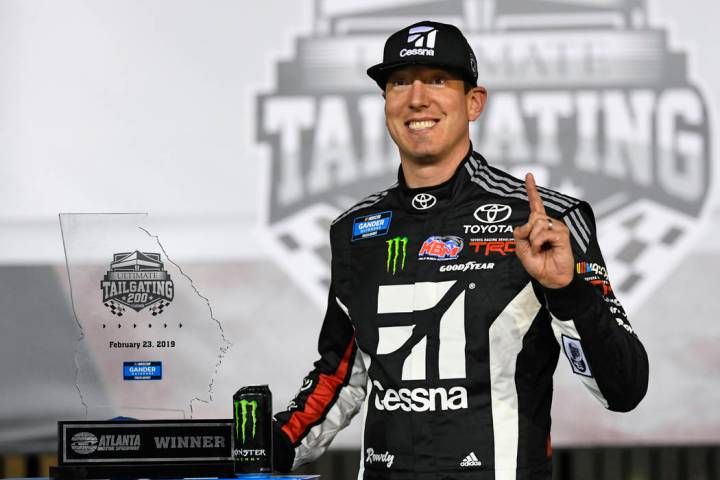 Kyle Busch poses with the trophy after winning the NASCAR Truck Series auto race at Atlanta Motor Speedway, Saturday, Feb. 23, 2019, in Hampton, Ga. (AP Photo/John Amis)