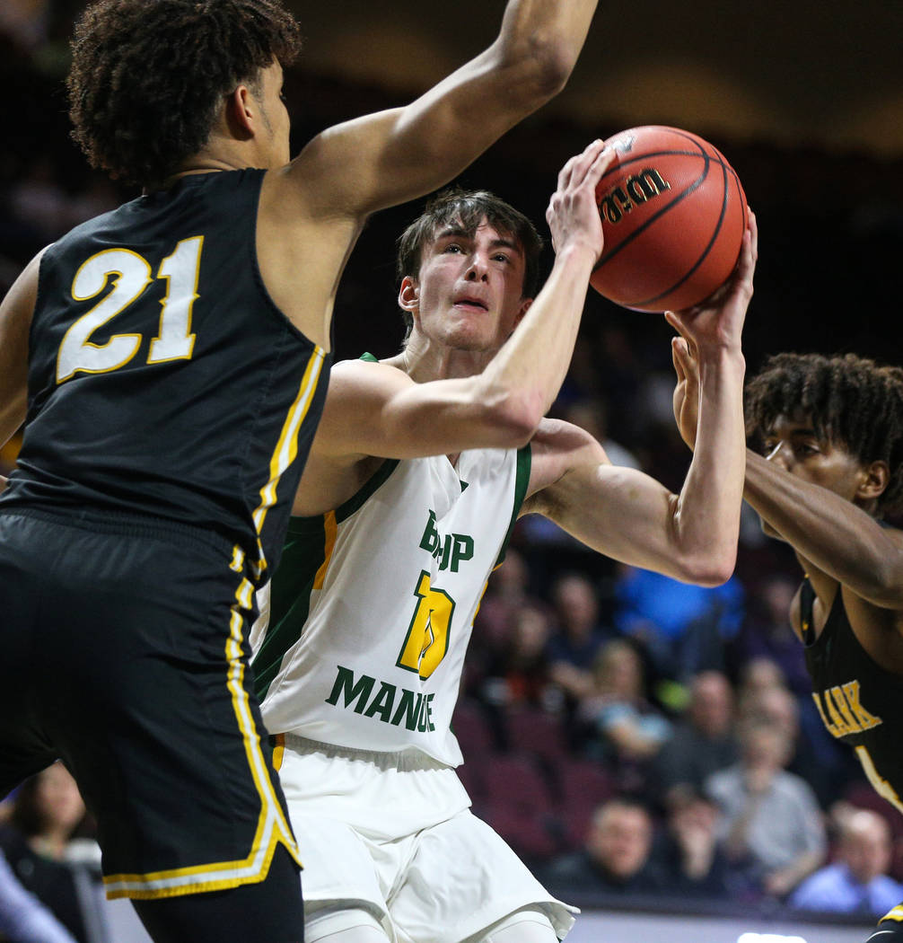 Bishop Manogue's Kolton Frugoli looks to take shot while being guarded by Clark's Jalen Hill (21) during the second half of a Class 4A state boys basketball semifinal game at the Orleans Arena in ...
