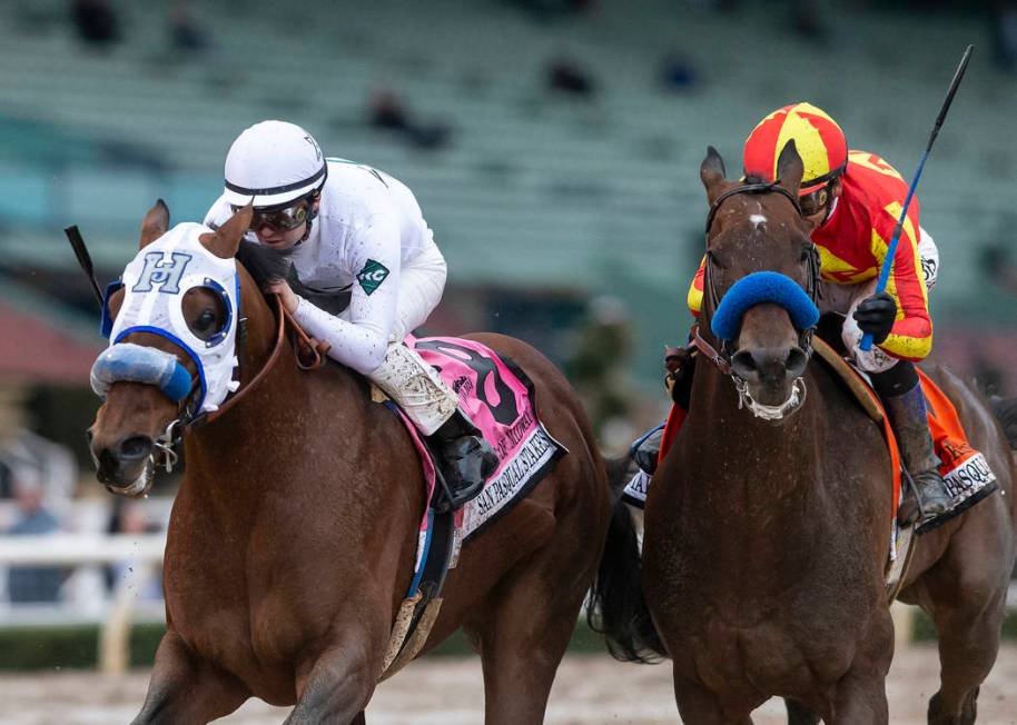 In a photo provided by Benoit Photo, Battle of Midway and jockey Flavien Prat, left, outleg McKinzie, with Mike Smith, to win the Grade II, $200,000 San Pasqual Stakes horse race Saturday, Feb. 2, ...