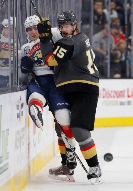 Vegas Golden Knights defenseman Jon Merrill (15) checks Florida Panthers center Frank Vatrano into the boards during the first period of an NHL hockey game Thursday, Feb. 28, 2019, in Las Vegas. ( ...