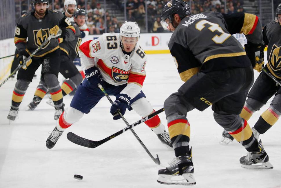 Florida Panthers right wing Evgenii Dadonov (63) competes for the puck with Vegas Golden Knights defenseman Brayden McNabb (3) during the first period of an NHL hockey game Thursday, Feb. 28, 2019 ...