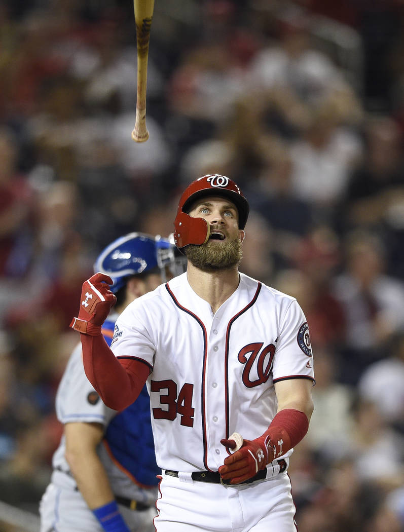 Washington Nationals' Bryce Harper tosses his bat after he flew out during the sixth inning of a baseball game against the New York Mets, Thursday, Sept. 20, 2018, in Washington. The Mets won 5-4 ...