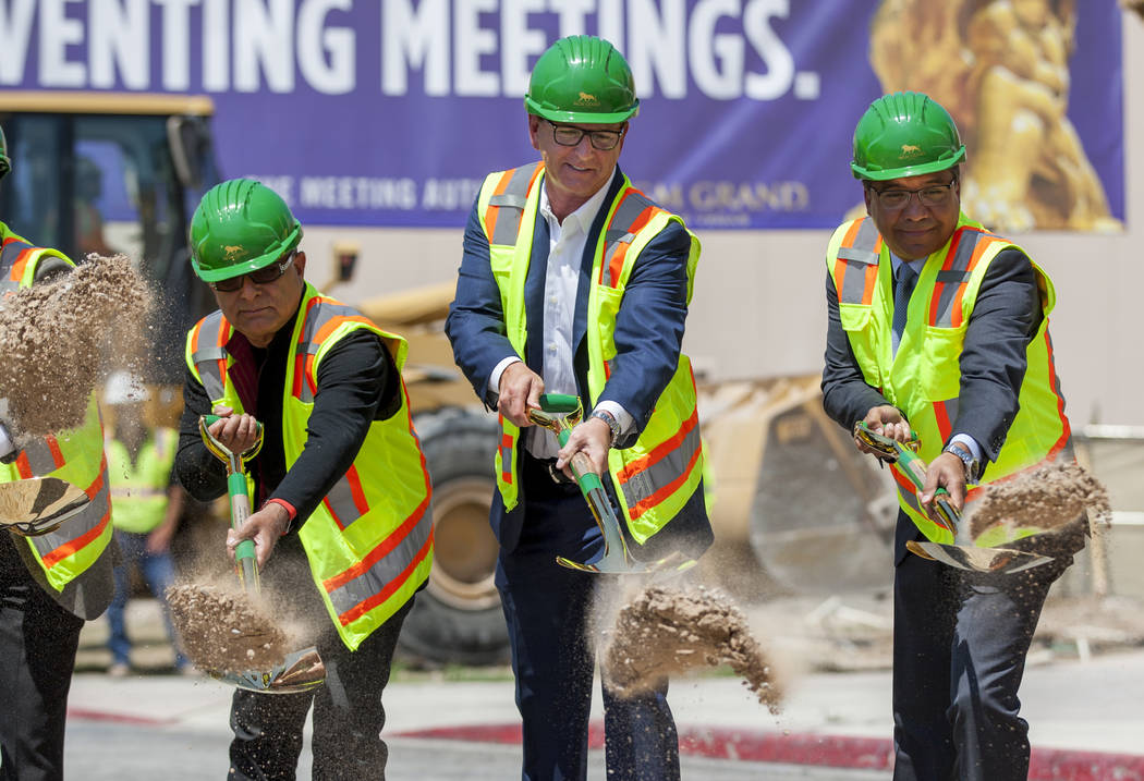 Deepak Chopra, an alternative medicine advocate, from left, Scott Sibella, president and COO of the MGM Grand, and Michael Dominguez, senior vice president and chief sales officer, shovel dirt at ...