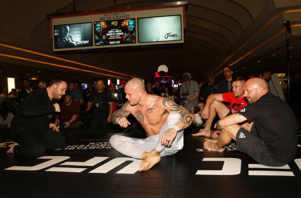 UFC light heavyweight title challenger Anthony Smith, center, prepares to give a fist bump to his coach Scott Morton, left, as Dustin Jacoby and Marc Montoya, right, look on during UFC 235 open wo ...