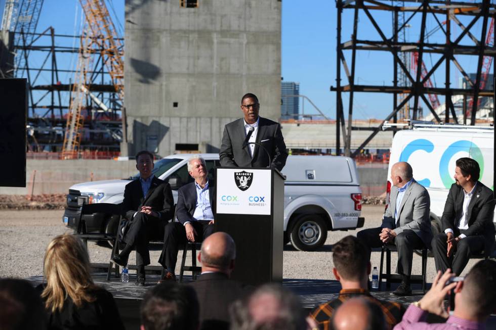 Derrick Hill, center, vice president for Cox Business, speaks during a press conference at the Raiders stadium construction site in Las Vegas, Thursday, Feb. 28, 2019. Cox Communications is becomi ...