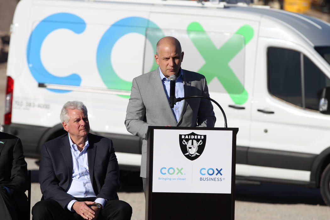 Raiders president Marc Badain, center, with Mike Bolognini, market vice president for Cox Communications Las Vegas, speaks during a press conference at the Raiders stadium construction site in Las ...