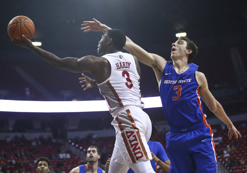 UNLV Rebels guard Amauri Hardy (3) goes to the basket past Boise State Broncos guard Justinian Jessup (3) during the first half of a basketball game at the Thomas & Mack Center in Las Vegas on ...