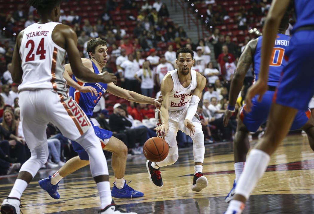 UNLV Rebels guard Noah Robotham (5) passes the ball to forward Joel Ntambwe (24) under pressure from Boise State Broncos guard Justinian Jessup (3) during the first half of a basketball game at th ...