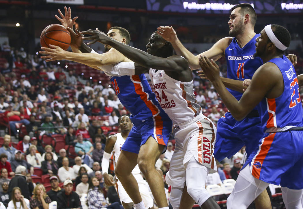 Boise State Broncos guard Alex Hobbs, left, and UNLV Rebels forward Cheikh Mbacke Diong (34) battle for a rebound during the first half of a basketball game at the Thomas & Mack Center in Las ...